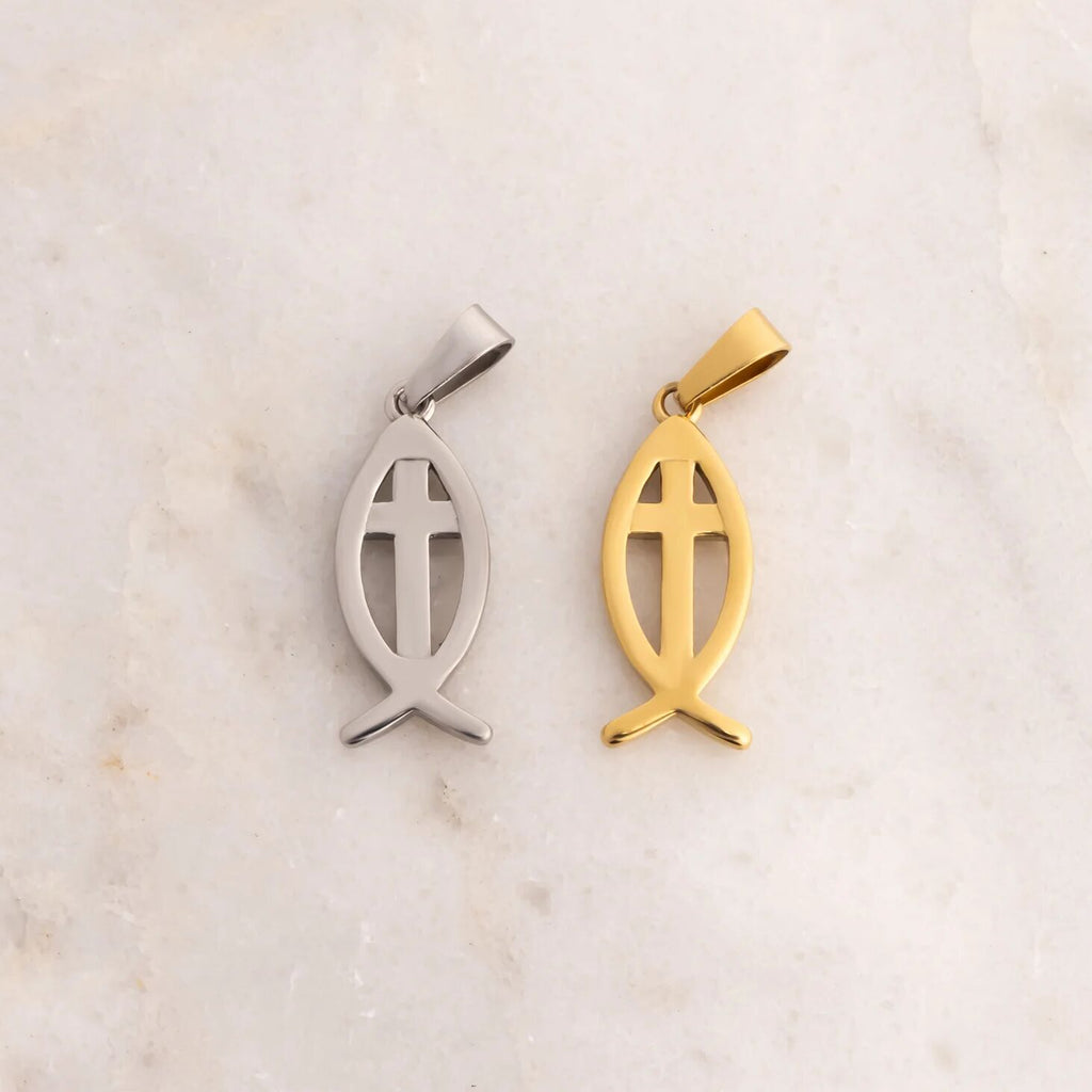 Gold and silver fish-shaped pendants on a marble background