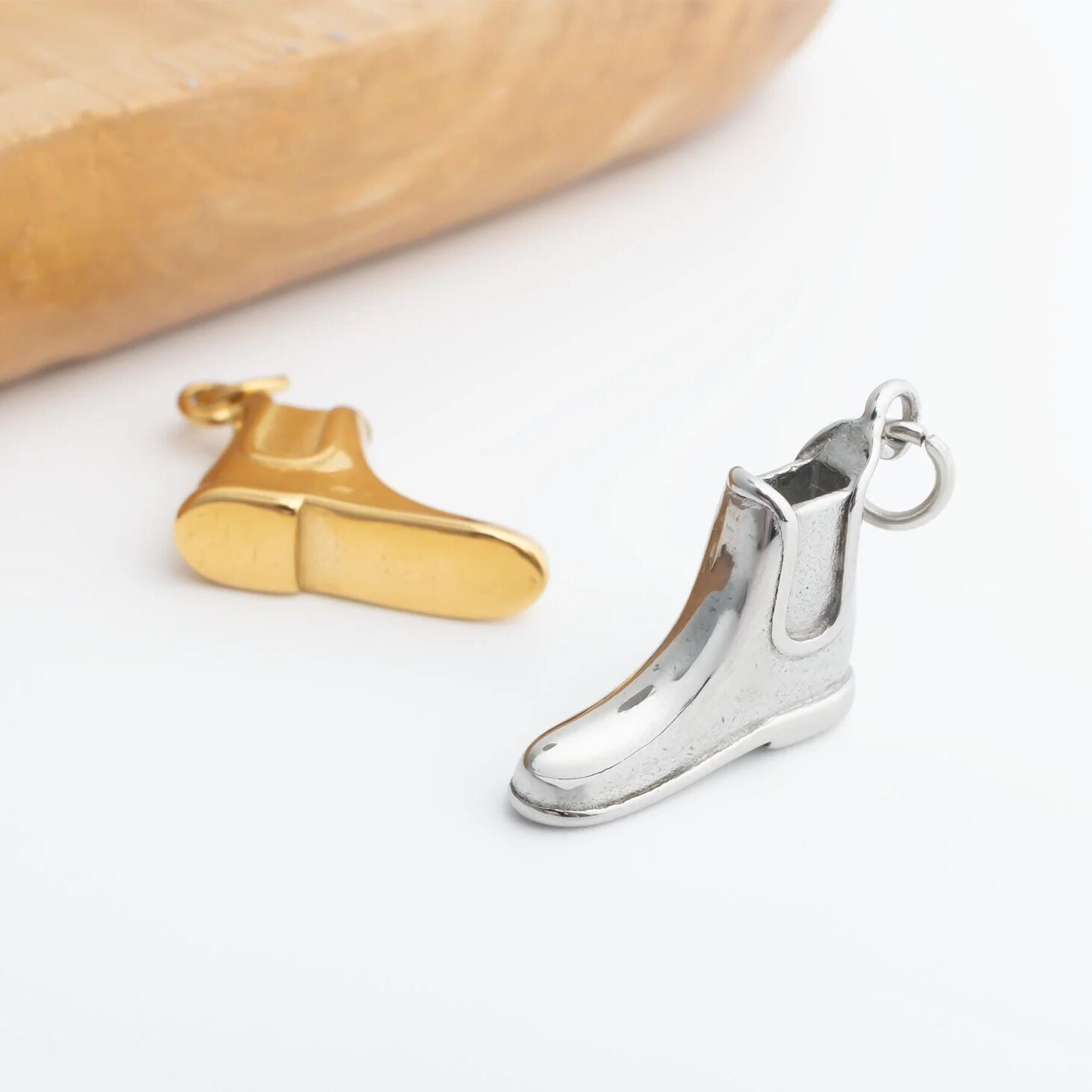 gold and silver boot charms on white background 
