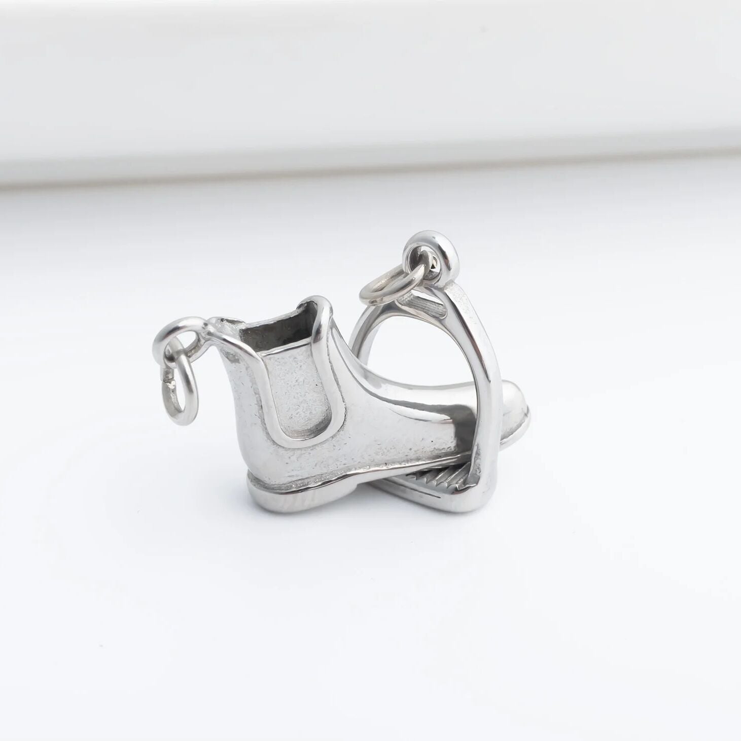 Silver boot charm on a white background