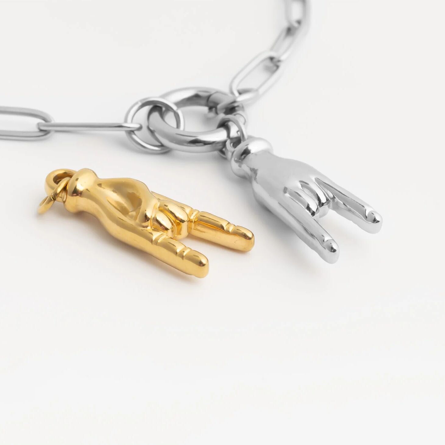 Two keychain charms, one gold and one silver, on a white background.
