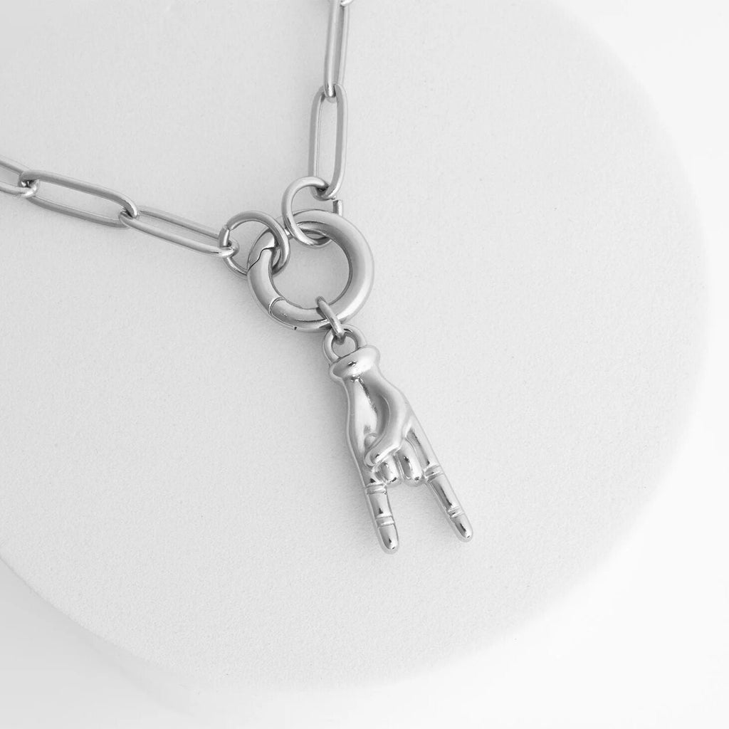 Silver necklace with a unique pendant on a light gray background