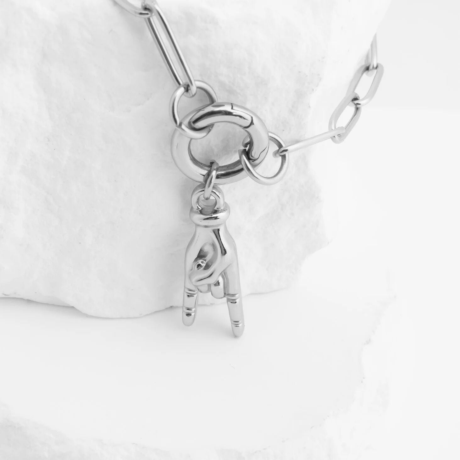 Silver bracelet with a unique charm on a white background