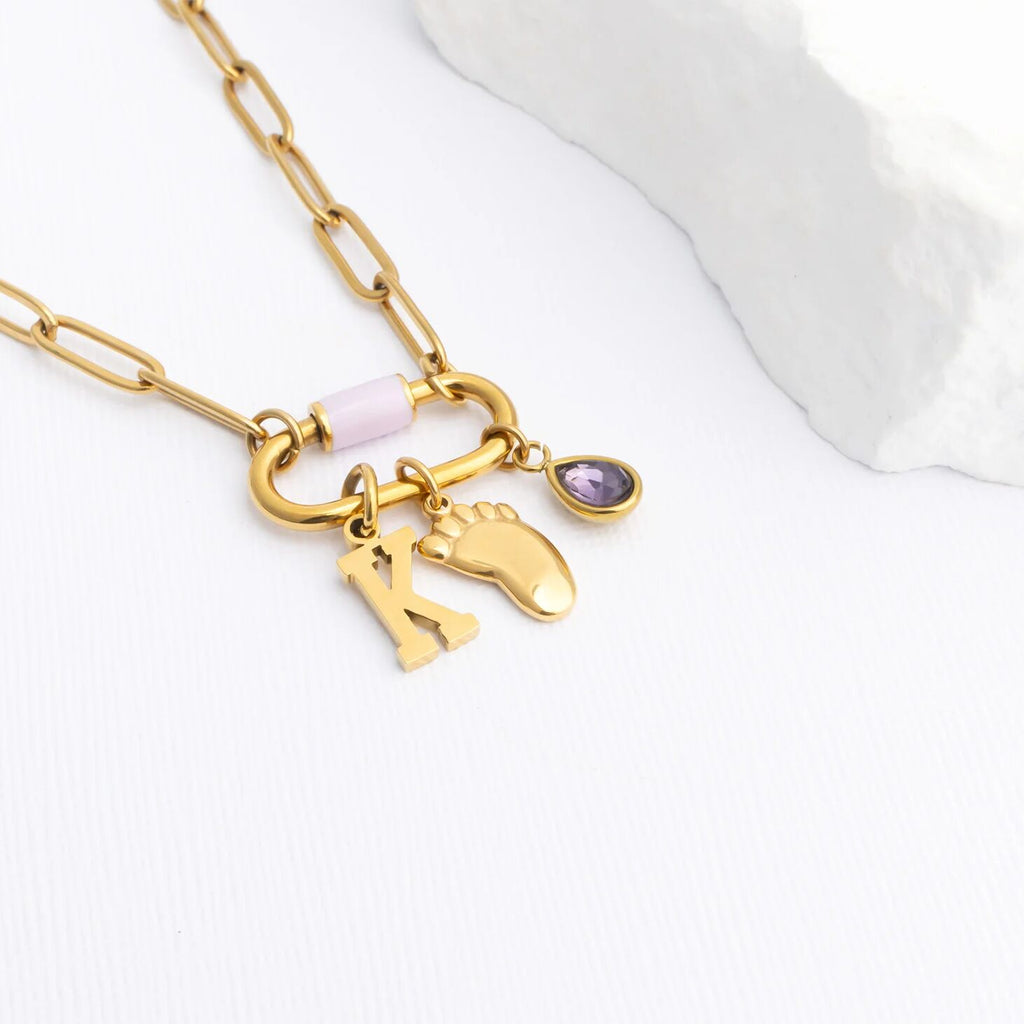 Gold necklace with Baby Foot Charm on a white background