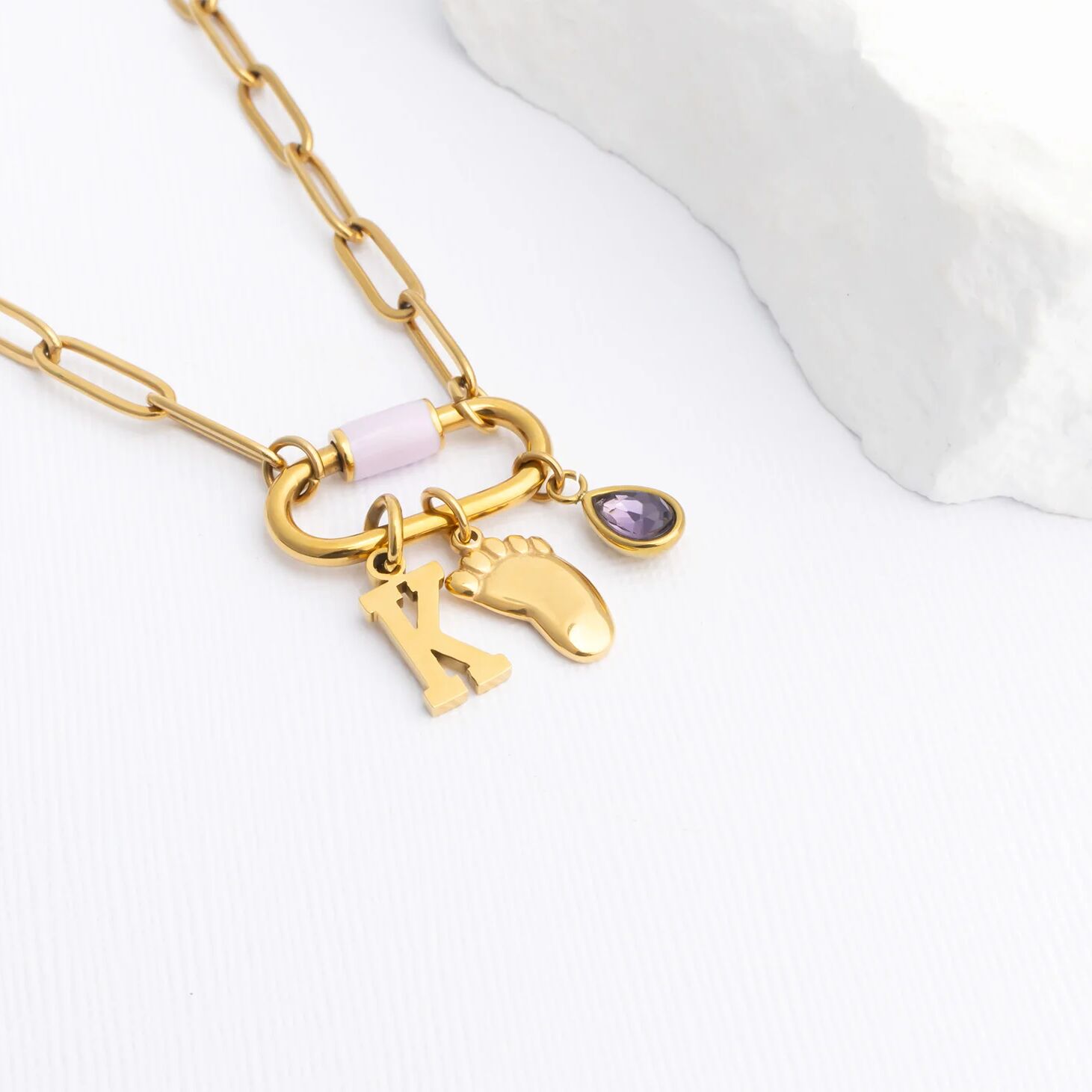 Gold necklace with Baby Foot Charm on a white background