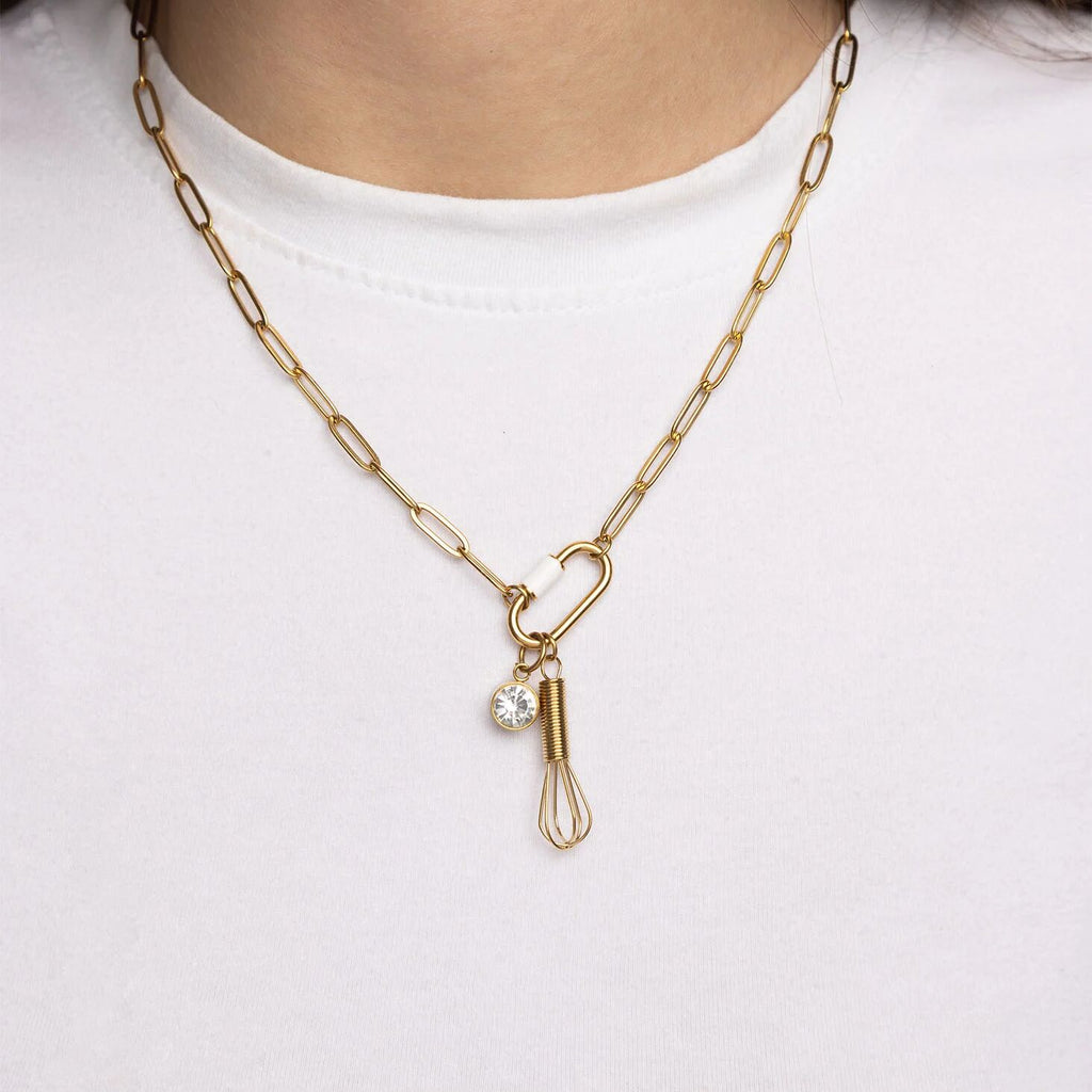 Gold necklace with a unique pendant on a white background
