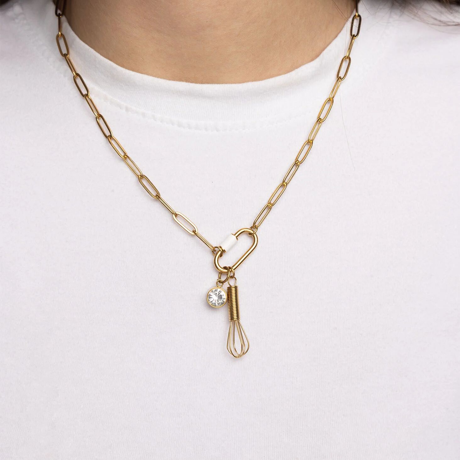 Gold necklace with a unique pendant on a white background