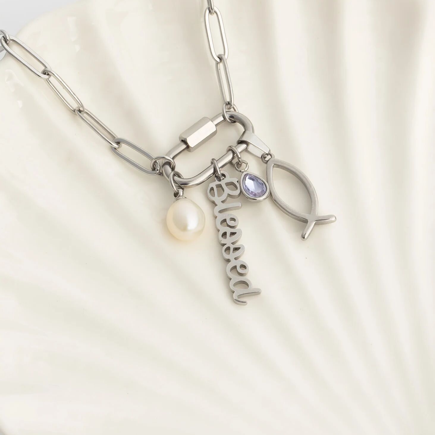 Silver bracelet with charms on a light beige background
