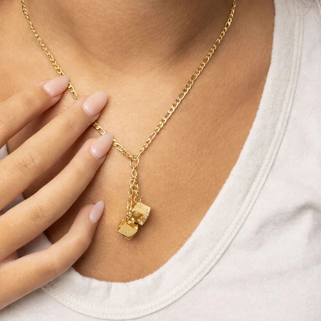 Gold necklace with a Dice Charm  pendant worn by a person