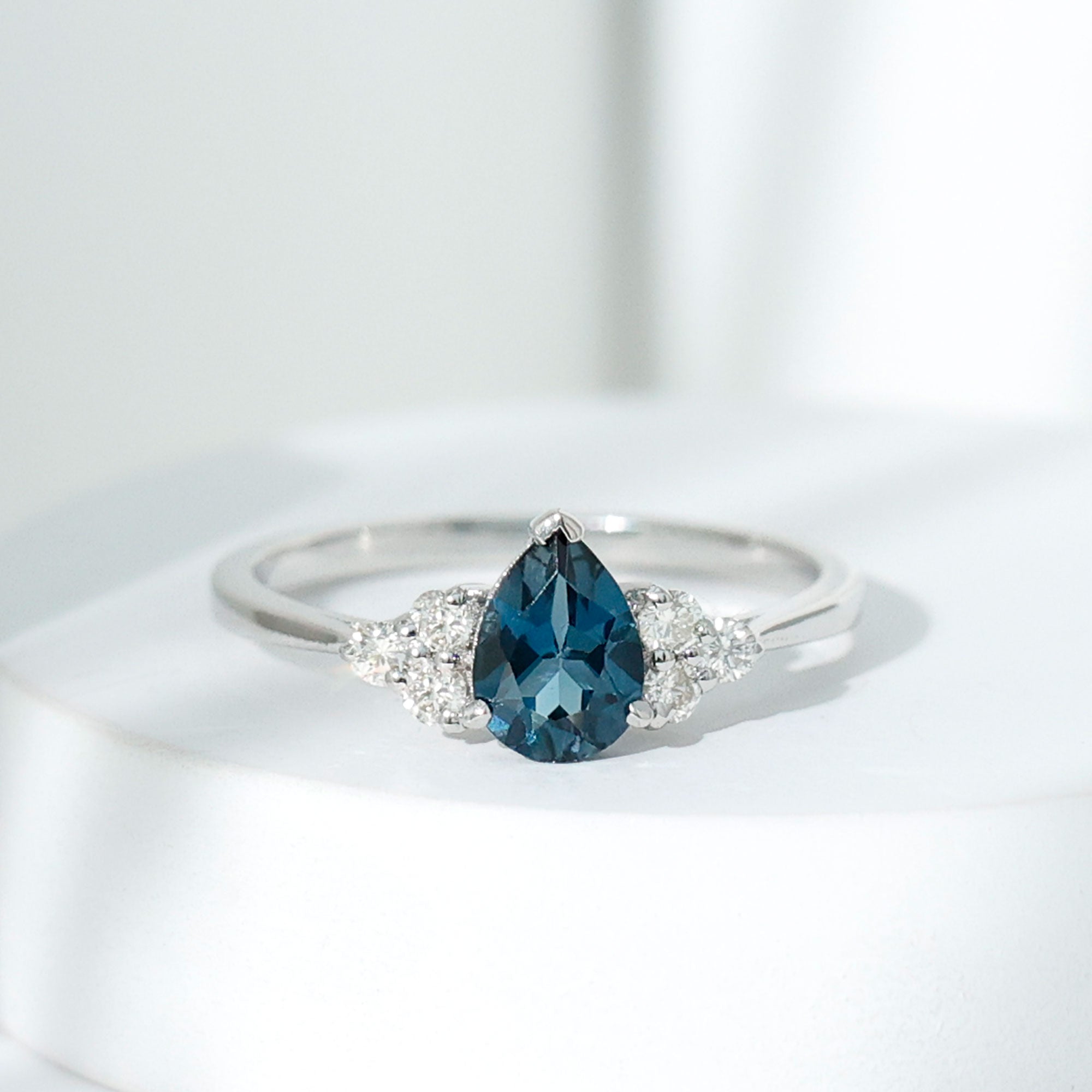 5X7mm Pear Shape London Blue Topaz Engagement Ring with Diamond Trio