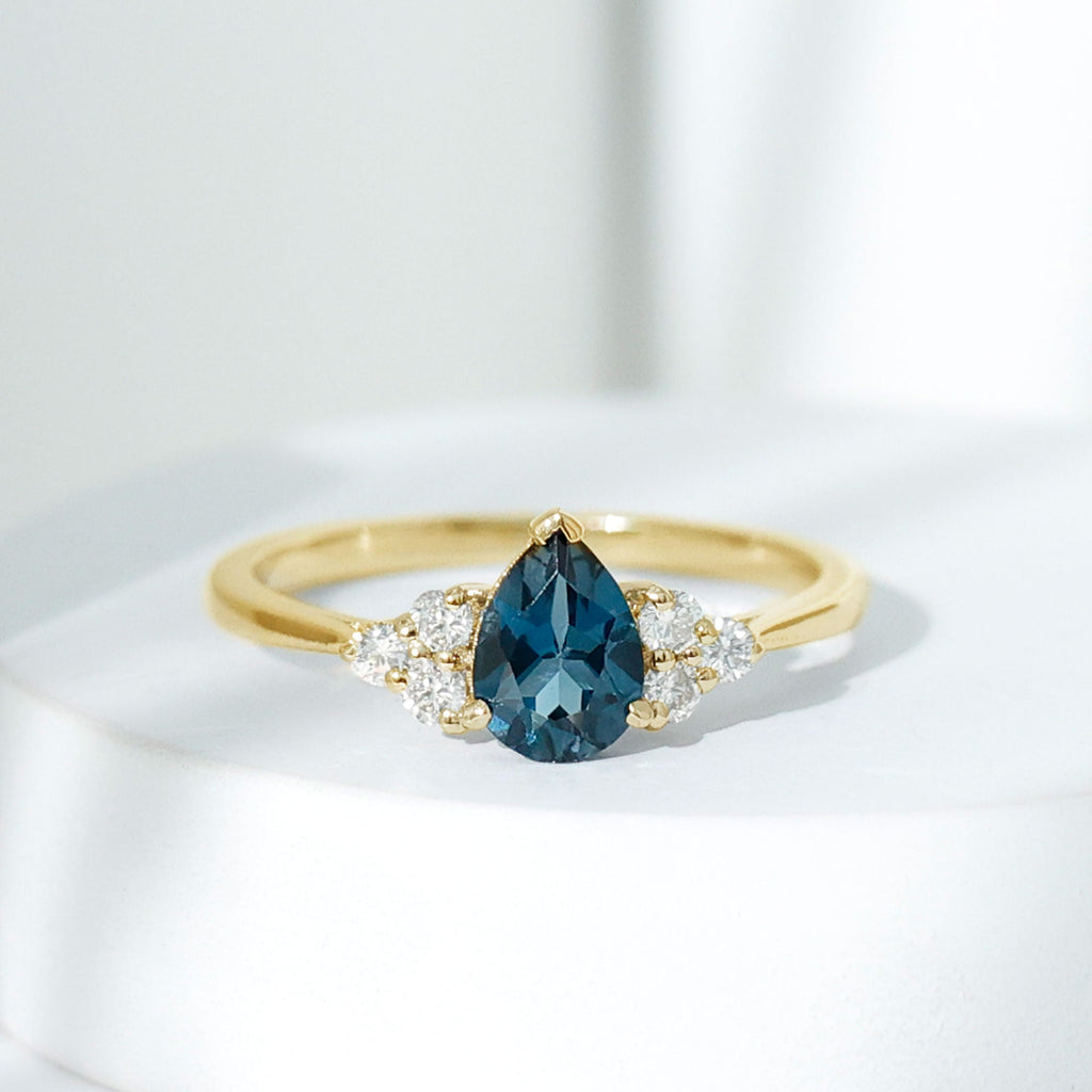 5X7mm Pear Shape London Blue Topaz Engagement Ring with Diamond Trio