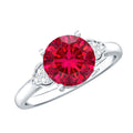 Lab grown ruby solitaire engagement ring with diamond trio on silver band