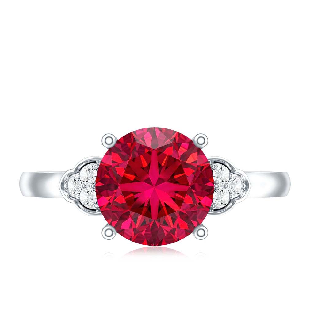 Lab grown ruby solitaire engagement ring with diamond trio on a silver band