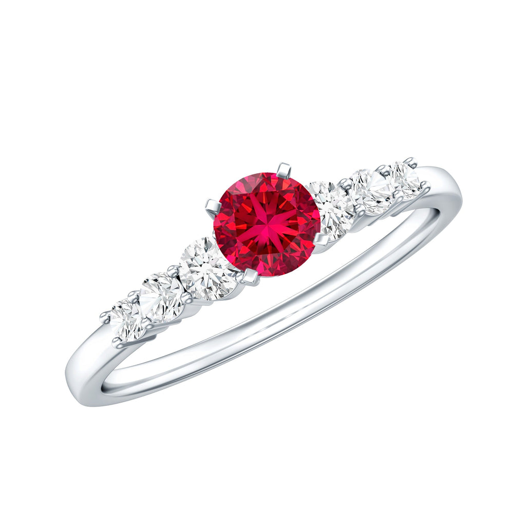 Graduated style lab created ruby and diamond promise ring with a central ruby and side diamonds on a silver band