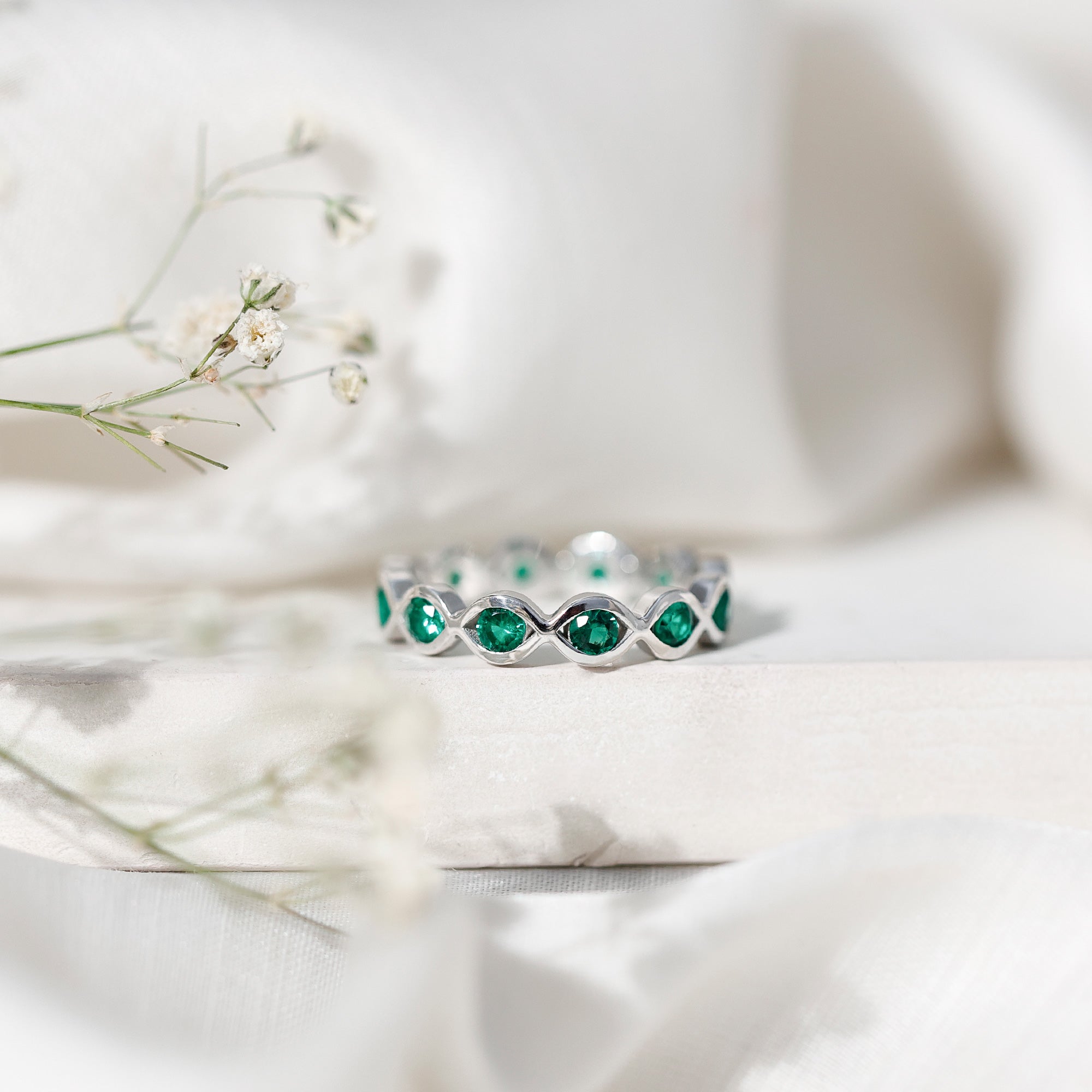 Lab Grown Emerald Ring – Infinity Twist Eternity Band With Brilliant Cut Stones