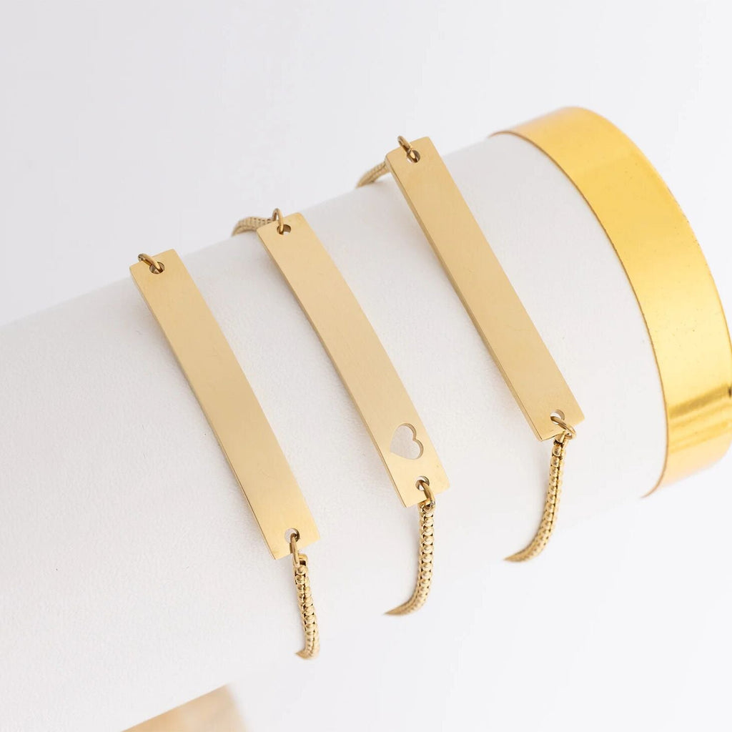 Gold bracelets with different designs on a white background